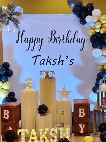 A sophisticated and modern decor theme for a second birthday. The black, white, and gold color scheme provides a chic and stylish alternative to traditional kids' party colors.
