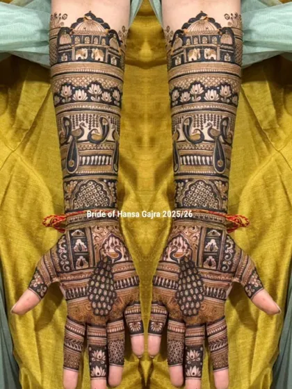 A beautiful example of a full-coverage traditional design. This mehendi features layers of royal architecture, peacocks, and lotus bands, creating a look of heritage on the hands.