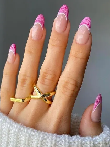 This unique French manicure features a beautiful pink marble effect on the tips, blending different shades of pink for a soft, stone-like texture. It's a trendy and artistic update to a classic style.