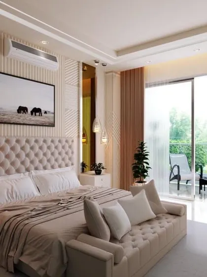 Beige is the new black. This bedroom design proves it with calm and warm vibes, featuring a tufted headboard, reflective surfaces, and an attached balcony for a bright and airy feel.