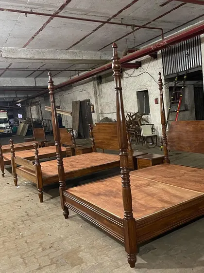 A lineup of four-poster beds being prepared for a hotel project in Panchgani, showing my capacity to handle large, multi-unit orders.