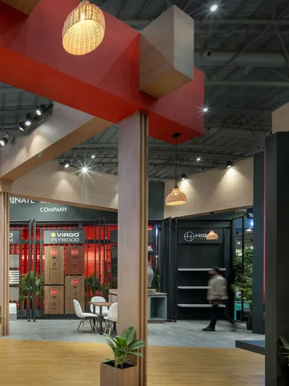 The interplay of light and shadow on the geometric volumes of the Virgo stall. The use of pendant lights and spotlights highlights the architectural details and creates a warm, inviting atmosphere.