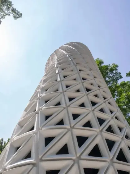 A low-angle view emphasizing the tower's helical, upward twist. This rotation is key to its function, designed through aerodynamic principles to increase surface area and efficiently channel air through its advanced filtration system.