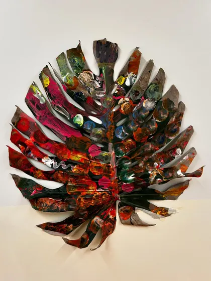 The finished community-painted leaf, a testament to the beauty of process art. Each mark, color, and pattern tells a story of a different person's contribution, creating a whole that is greater than the sum of its parts.