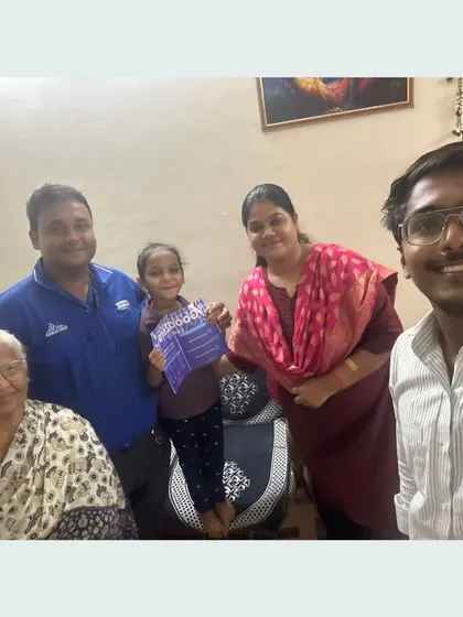 A family with their grandmother and a young child, all happy to be part of the solar revolution.