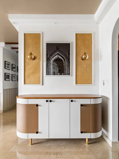 We designed this discrete bar area under the stairs to meet the client's requirements. The curved design and soft color palette sync beautifully with the arches seen throughout the home.