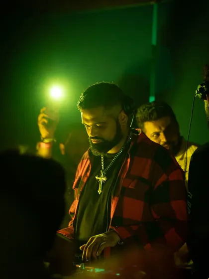 A focused shot of me at Waikiki, Mumbai. The green lighting and my plaid shirt give this a different, more relaxed vibe compared to the intense techno sets.