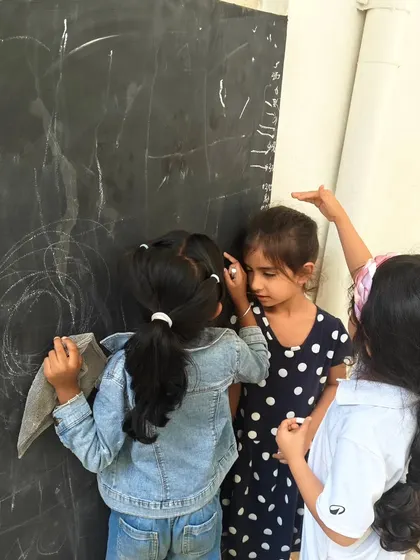 More scenes of mathematics in action, from children measuring themselves against a chalkboard to creating secret rooms of math puzzles. These images show how math is a joyful, creative, and collaborative language at our school.