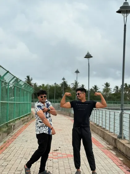 Having fun while flexing with a friend. Fitness should be enjoyable.