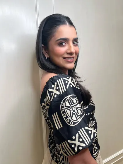 Another view of this chic and polished look. The simple hairstyle and soft makeup work together to highlight the client's natural beauty with sophistication.