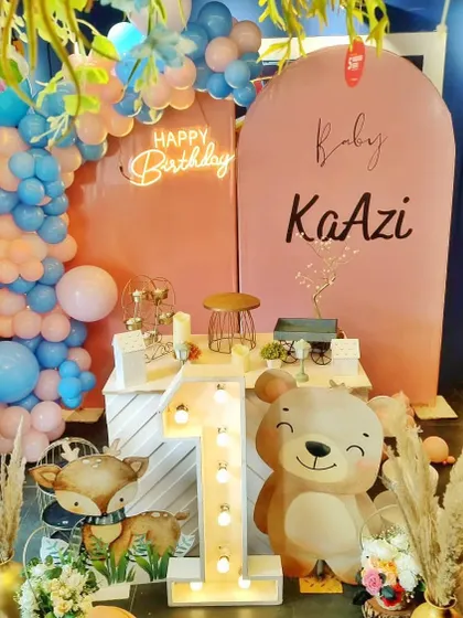 A woodland-themed first birthday for "Baby Kaazi," with cute animal cutouts and a rustic, boho feel.