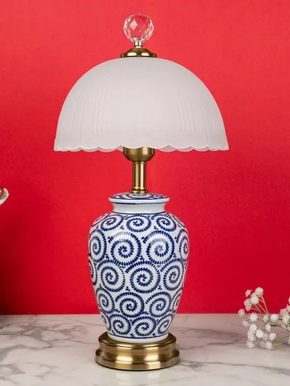A playful spiral pattern gives this blue pottery lamp a more contemporary feel. Paired with the soft glow of the frosted glass dome shade, it's a unique piece that bridges classic and modern styles.