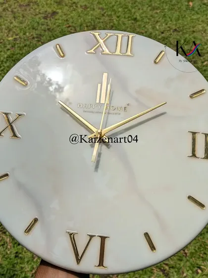 A clean and elegant branded wall clock with a light grey marble effect and gold Roman numerals. This is a great example of a sophisticated corporate gift.