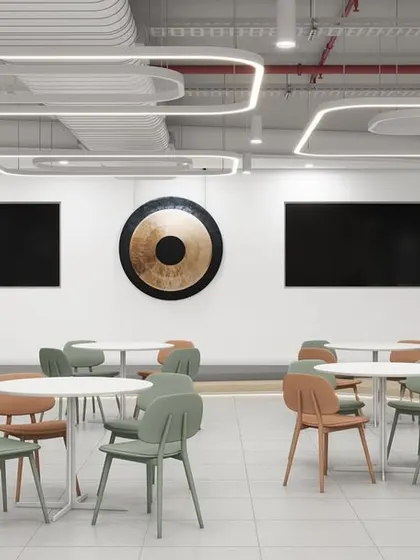 A 3D render of a large, open-concept cafeteria or town hall space. The design includes flexible seating arrangements and large screens, making it suitable for dining, presentations, and company-wide events.