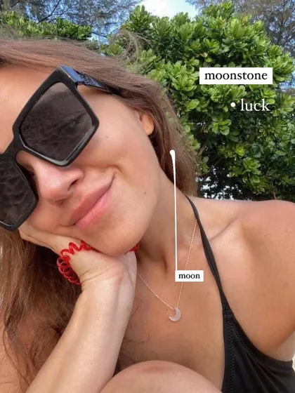 A lifestyle shot of the White Moonstone Luna pendant. It's a beautiful talisman for attracting good fortune.