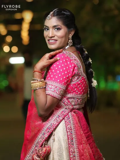 A close-up of this beautiful bride or guest in a pink and cream lehenga. The intricate details on the blouse and the traditional jewellery are stunning.