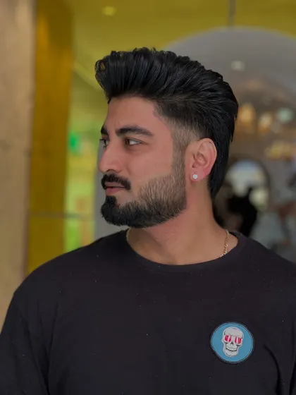 This side profile highlights the precision of the fade and the expert styling of the hair on top. A truly clean look.