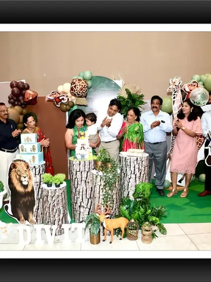 A happy family photo from Divit's jungle safari themed first birthday. It's a joy to see everyone celebrating together in front of my decor.