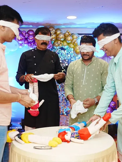 A hilarious blindfolded diaper changing game for the men at a baby shower. It's always a highlight and gets everyone laughing.