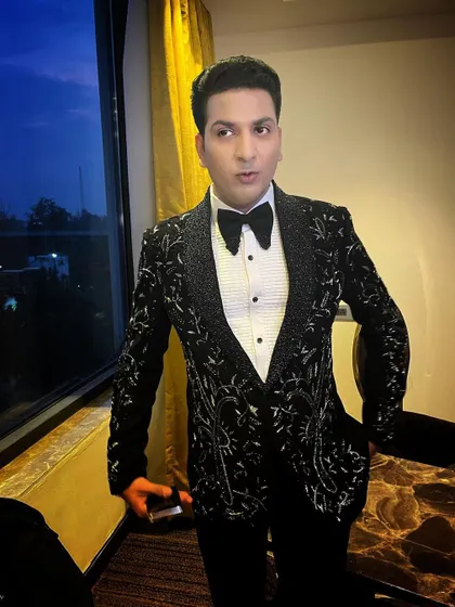 This groom is ready for a grand reception in a heavily embellished black tuxedo jacket. My makeup and hair styling ensure he looks spectacular under the evening lights.