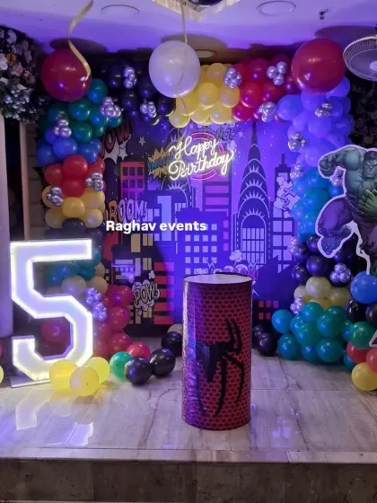 A closer look at the superhero birthday stage decoration. You can see the detailed balloon work, character cutouts, and the glowing number '5' that make the setup exciting for kids.