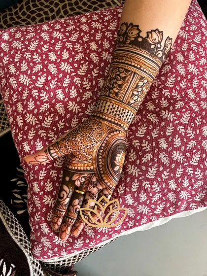 A close-up of a single hand, showcasing a lotus-centric design with fine details and beautiful shading.