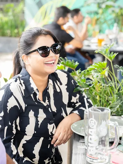 A candid shot of a guest smiling, enjoying the relaxed and happy atmosphere.