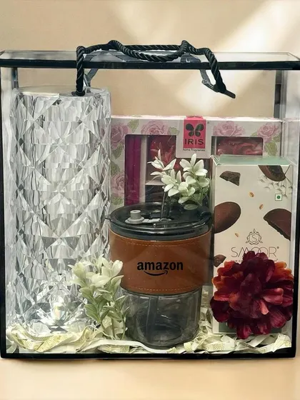 This modern corporate gift, housed in a clear acrylic bag, features an Amazon-branded tumbler, a crystal-cut vase, and fine chocolates. It shows how your brand can be elegantly integrated into a high-end gift.