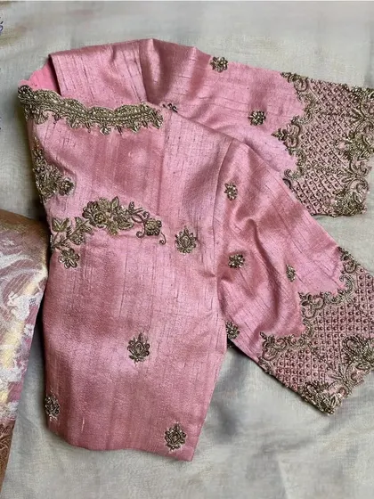 A blush pink raw silk blouse with a scalloped neckline and exquisite zardosi and bead embroidery.