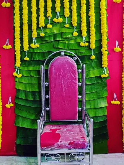A vibrant and traditional backdrop we designed for a seemantha, or baby shower. We used fresh banana leaves layered behind bright yellow marigold garlands to create a classic, auspicious setting for the mother-to-be.