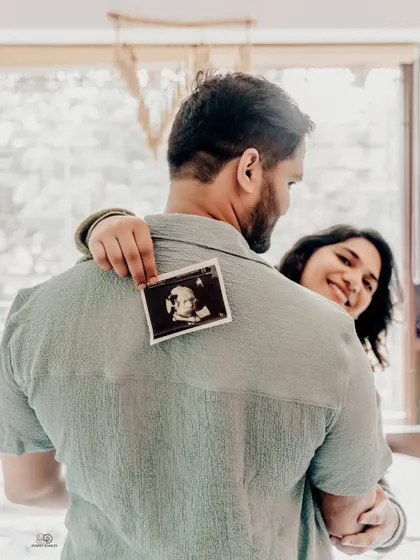 A sweet and intimate moment captured during an at-home lifestyle session. Holding up the ultrasound photo is a simple, powerful way to celebrate the little life you've created together.