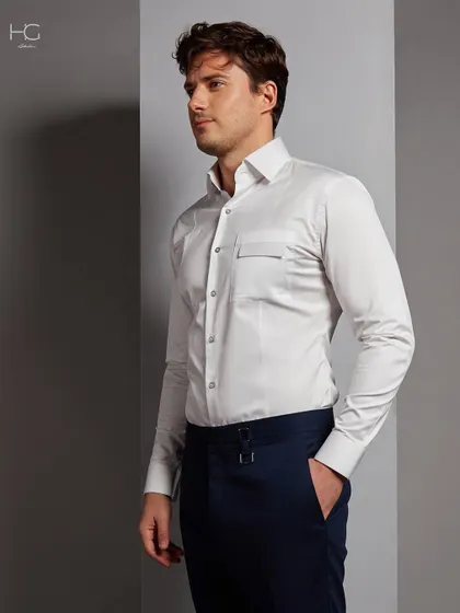 Timeless sophistication is in every stitch. This crisp white shirt features a unique pocket detail, elevating it from a simple basic to a refined statement piece.