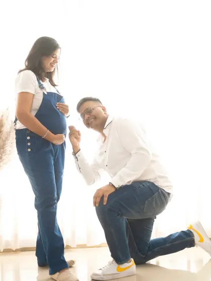 The dad-to-be listens to the baby bump in this sweet and casual shot. It's a simple, heartfelt pose that captures the anticipation of waiting for their little champ.
