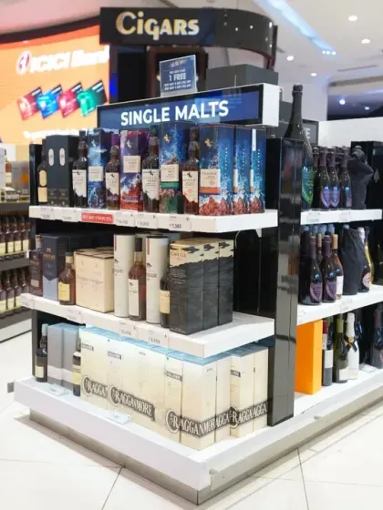 A close-up of a single malts and cigars display. We focus on clear labeling and attractive product arrangement, ensuring every detail is sharp and legible for commercial use.
