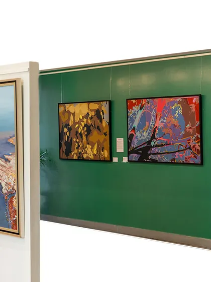 Another perspective of our gallery space during the South Edition exhibition, showcasing abstract works against a deep green wall, creating a powerful visual contrast.