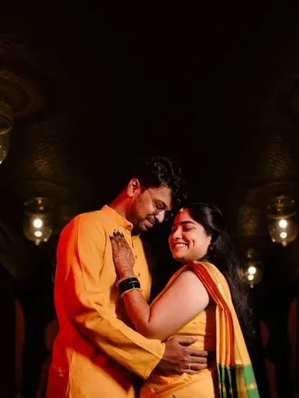 An intimate, low-light portrait of the couple, their faces close together, showcasing the romance and emotion of their wedding day.
