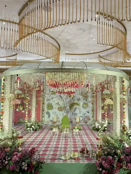 The 'Janavasam' ceremony, marking the groom's arrival, is set against a backdrop inspired by the tree of life. The design uses earthy terracotta and teal tones with handcrafted floral embossed fragments to celebrate this vibrant Tamil tradition.