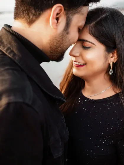 The gentle touch and shared smile in this close-up portrait show the couple's easy comfort with each other. These are the authentic interactions I aim to capture during our session.