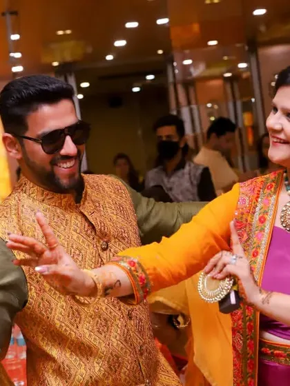 The dance floor is buzzing during the Haldi party. This photo captures the groom dancing with family, showcasing the energy and involvement of all the guests.