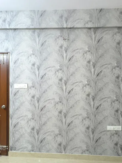 A full view of the grey leaf stalk wallpaper next to a door, showing the continuous vertical pattern.