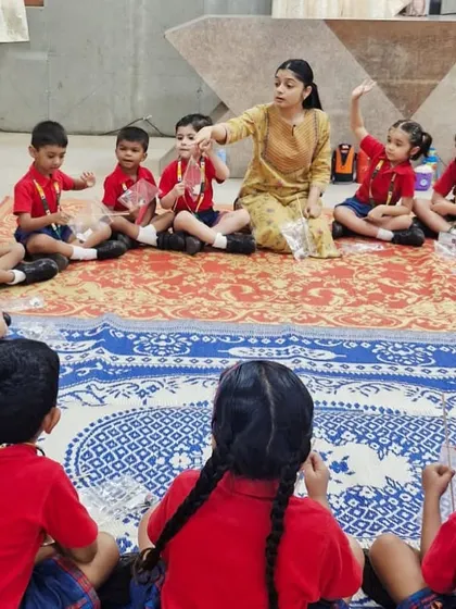 An instructor leads a circle time activity with kindergarteners, explaining the science behind the project in a simple and engaging way.