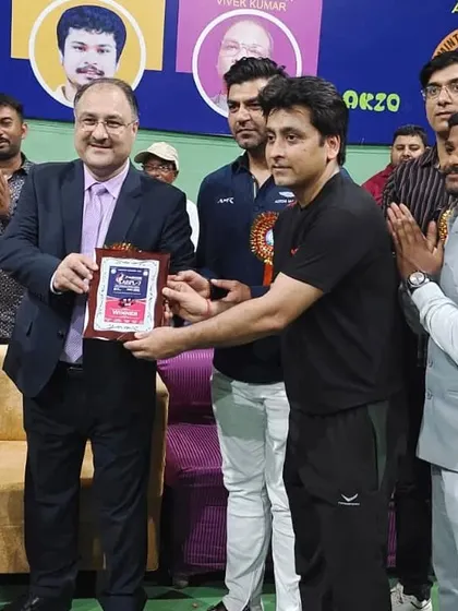 Head Coach Ravindra Singh receiving a plaque in recognition of his performance and victory at the Agra Badminton Premier League. We are proud to have such accomplished leaders guiding our students.