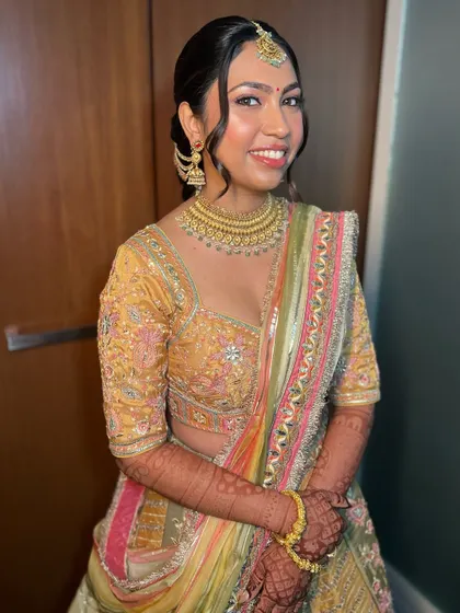 Pari's smile says it all. The makeup is subtle enough to let her natural beauty shine, but glamorous enough for a sangeet celebration.