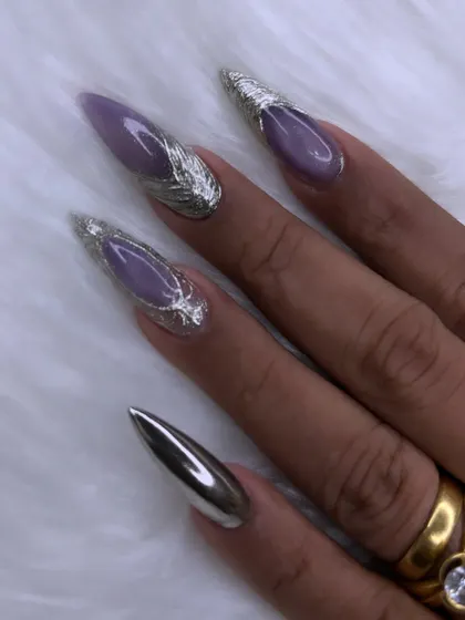 Another angle of the purple and chrome stiletto nails, showing the sharp, clean shape and the beautiful contrast between the glossy purple and metallic silver.