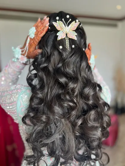 Another angle of the butterfly and pearl hairstyle, showing how the accessories are placed to create a dreamy look.