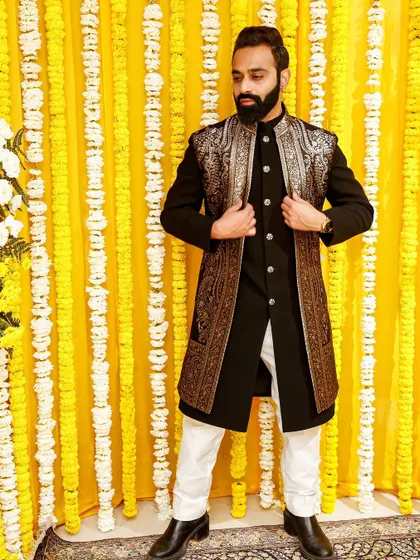 Make an impression at your friend's wedding with this black Indo-Western outfit, featuring a long jacket with stunning gold embroidery. It's a look that is both powerful and elegant.