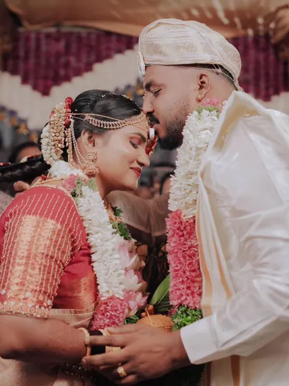 A tender forehead kiss from the groom to his bride, a perfect, emotional wedding day shot.