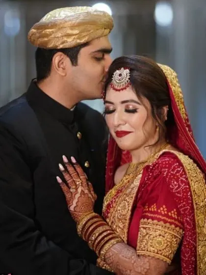 This professional wedding photo beautifully captures the final bridal look. The deep red stain of the henna I applied is clearly visible, perfectly matching her red lehenga and completing her traditional bridal appearance.