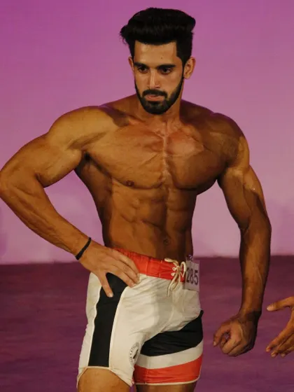 Another angle from the Musclemania stage, focusing on the V-taper.