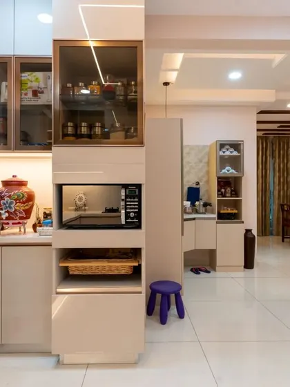 This kitchen features a tall unit that combines storage with a built-in microwave, demonstrating our expertise in creating space-efficient modular solutions.